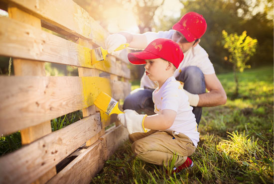 father and son diy painting fence